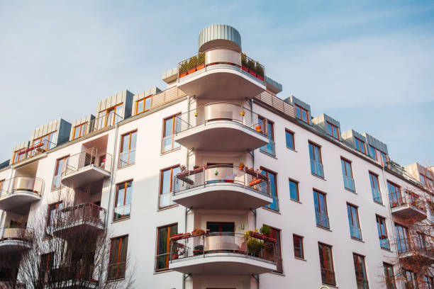 istock white modern apartment building with curved balcony on the corner 922879058