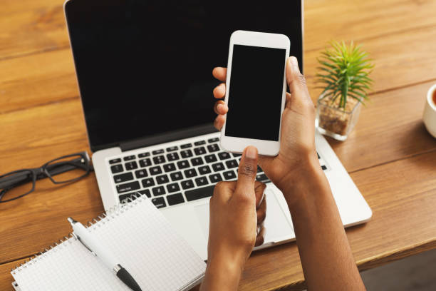 istock Black woman using smartphone at workplace, closeup 922879262
