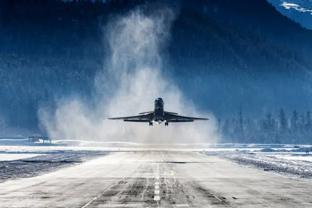 Business Jet departing a snowy airfield