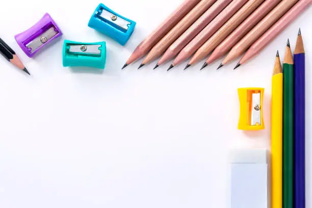 Many pencil-sharpener, eraser, and many pencils isolated on white paper background. with copy space for your text."n
