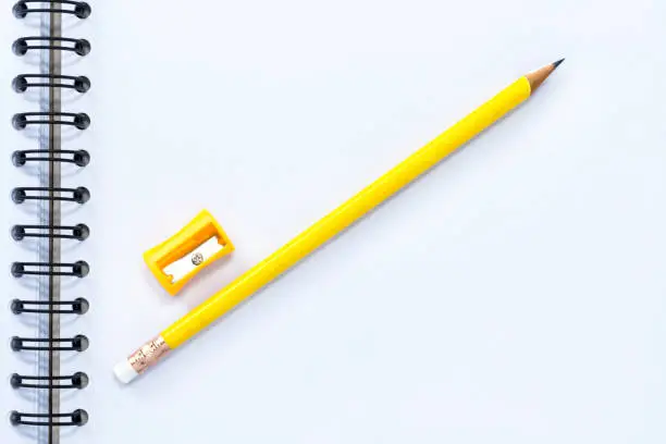 pencil-sharpener and pencil isolated on notebook background.  with copy space for your text.