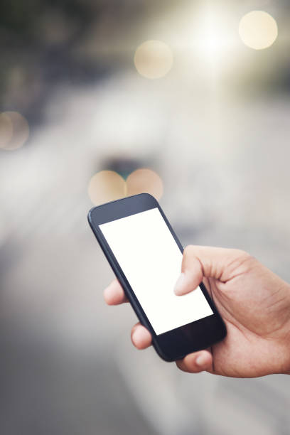 Cropped shot of an unrecognizable man using a cellphone in the city