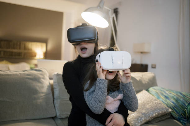 istock Mother and daughter using virtual reality headsets at home 922883452