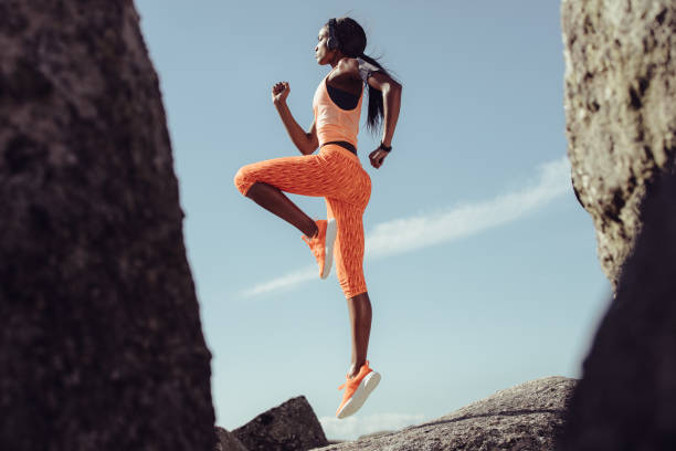 istock African female athlete jumping and stretching 922883828