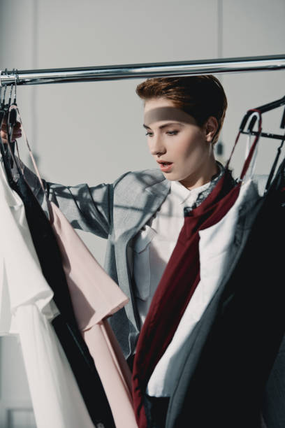 istock excited young woman choosing clothes in store 922887162