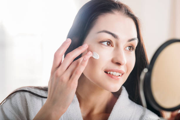 istock Woman applying face cream 922890496