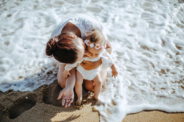 istock Mother and daughter by the sea 922890832