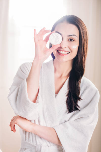 istock woman showing open jar of cream 922890854