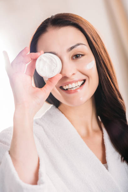istock woman showing open jar of cream 922890876