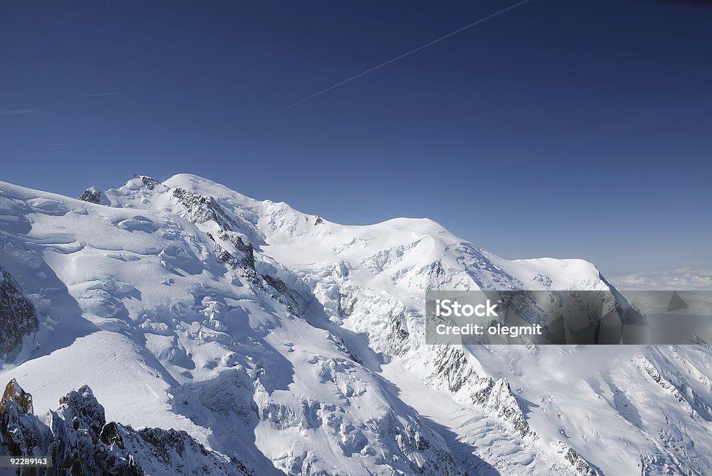 Blue sky above peaks and glacier, the Alps  Above Stock Photo