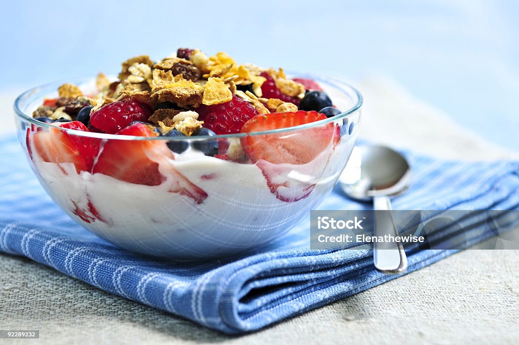 Bowl of yogurt, granola and fruit on a checkered tablecloth Serving of yogurt with fresh berries and granola Berry Fruit Stock Photo