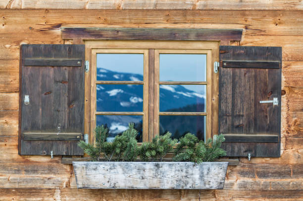Vintage Window of old alpine house. Wooden rustic background. stock photo
