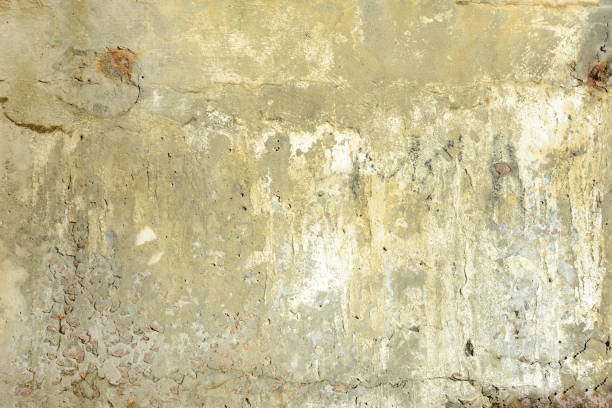 istock Yellow dirty concrete wall with cracks and holes. Background with texture. 922893574