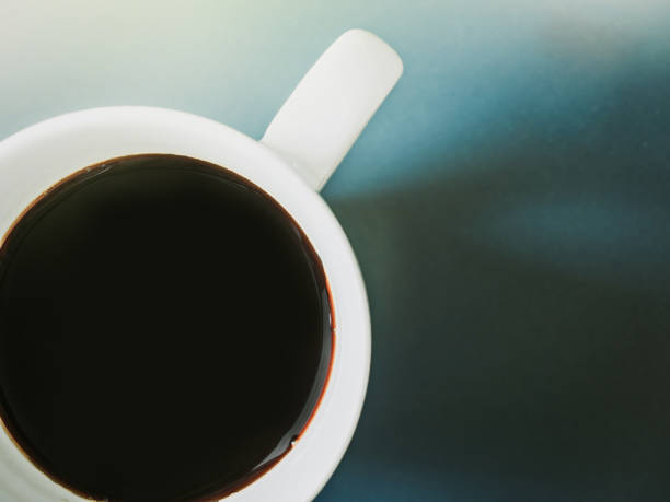 istock flat lay from black coffee in white cup from morning time  with blue background and shadow 922894086