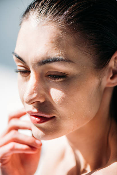 istock woman with droplets on face 922894378