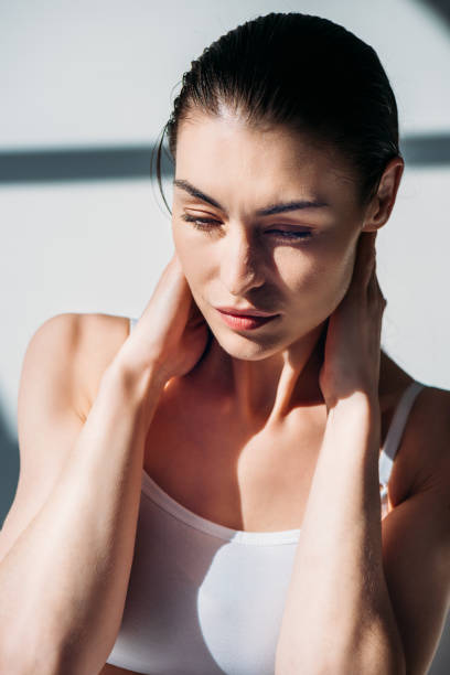 istock woman slicking back wet hair 922894420