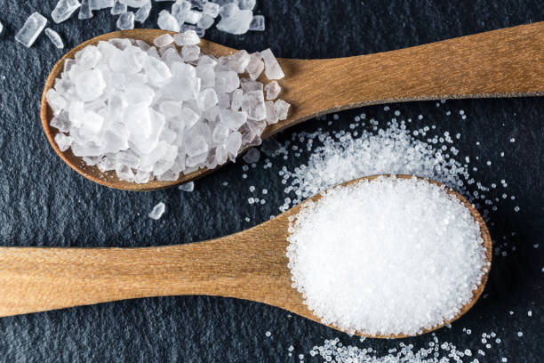 istock Different types of salt. Top view on two wooden spoons 922901934