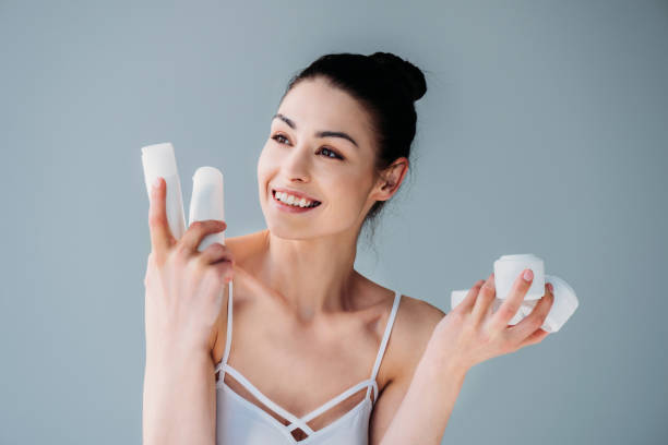 istock Smiling woman holding cosmetic containers 922905666