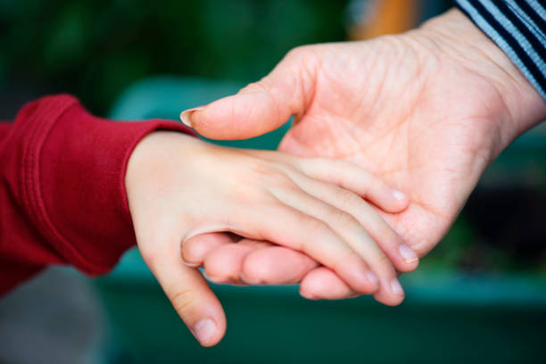 istock Grandmother Holding Her Grandson's Hand 922906162