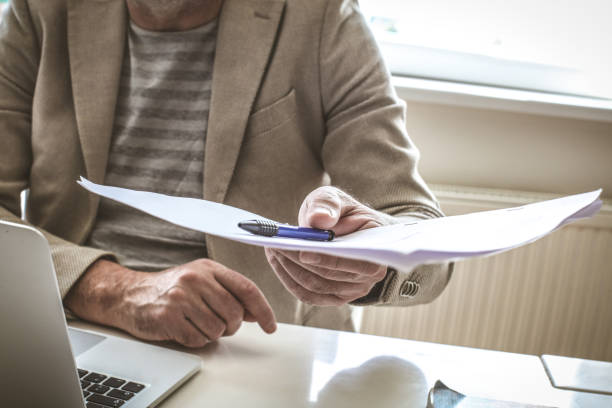 istock Close up of senior businessman giving documents. 922906270