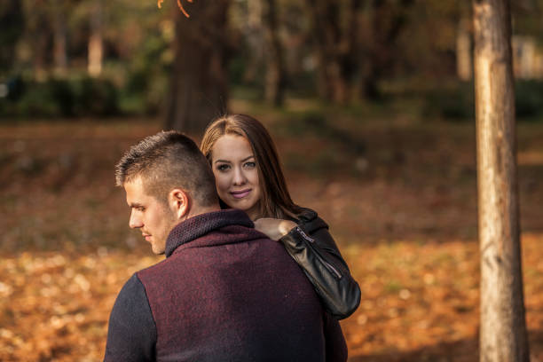 istock Happy young couple in autumn park 922918640