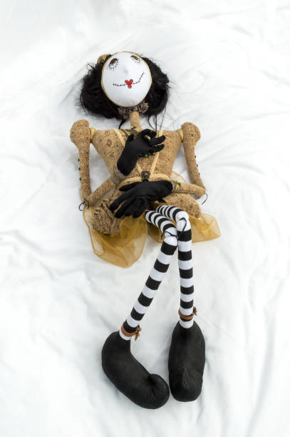 istock Creepy steampunk doll lying on back knees raised. Vertical. 922918908