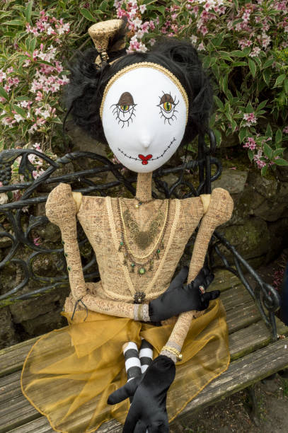 istock Creepy steampunk doll sitting on garden bench. Close up. 922919142