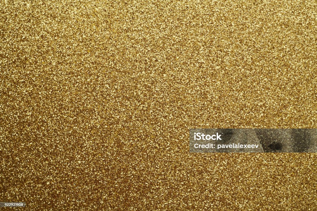 Golden glittering background. Golden glittering background. Abstract background and texture for design. Glitter Stock Photo