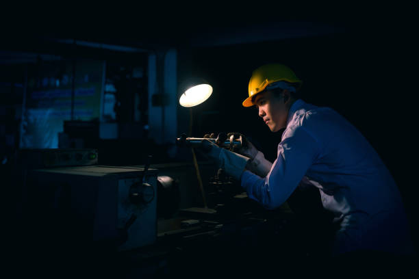 istock Asian engineer man wearing safety helmet checking and using an equipment in the laboratory. concept of manufacturing mechanical workshop measurement and tools. 922922356
