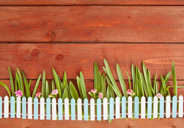 istock Little picket fence on wooden background 922930318