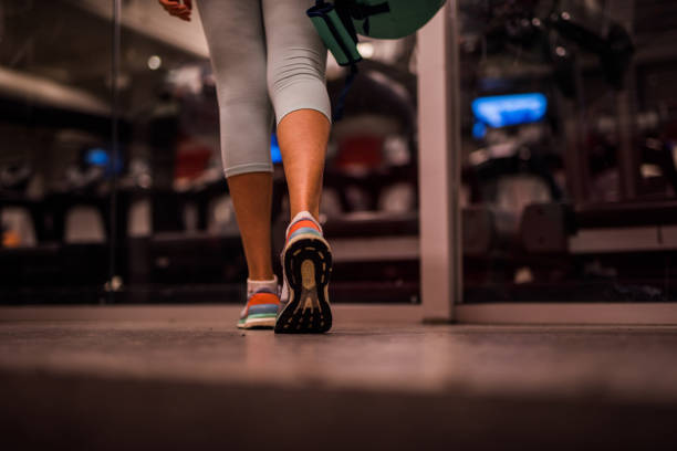 Close up of unknown woman walking in the gym. stock photo