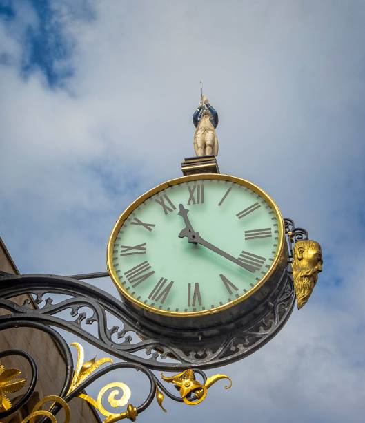 istock Ornamental clock set hight above the street below. 922938272