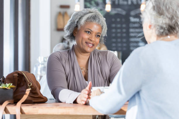 istock Senior women enjoy coffee together 922939832