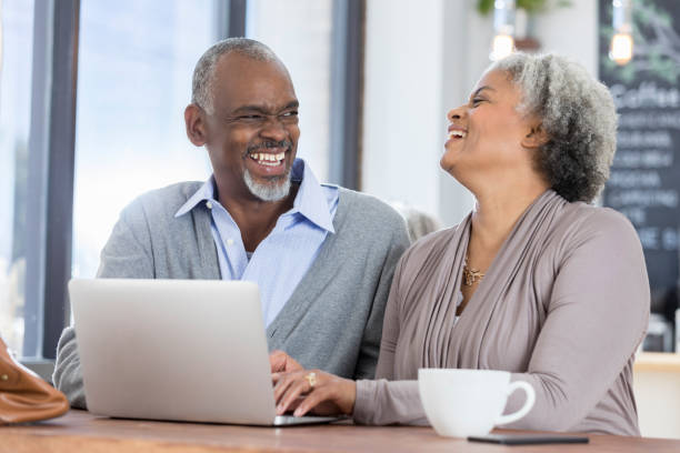 istock Senior woman laughs while having coffee with husband 922939896
