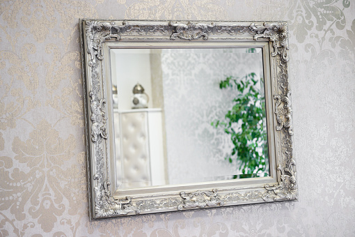 Mirror With Ornate Frame On Decorated Wall