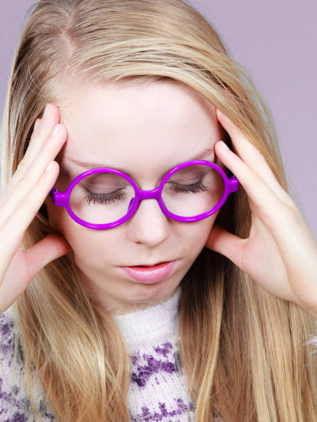 istock Nerdy woman in big holding head 922943850