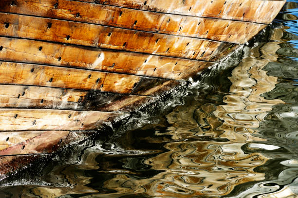 part of wooden ship sheathing, reflected in water
