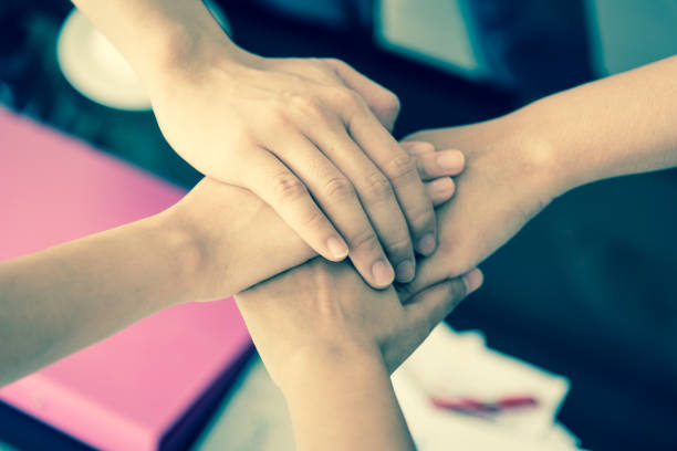 istock business has hands stacked together. 922947432
