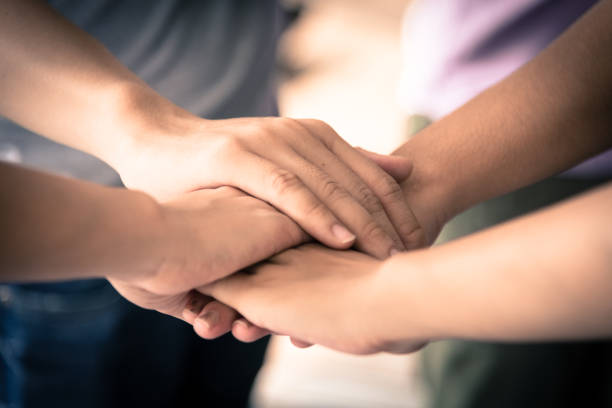 istock business has hands stacked together. 922947440
