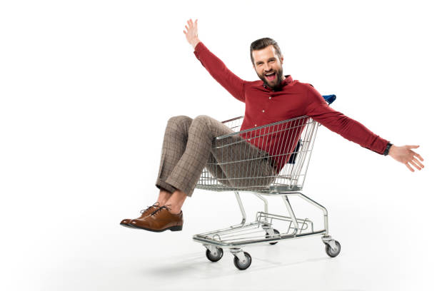 istock cheerful man sitting in shopping cart isolated on white 922949882