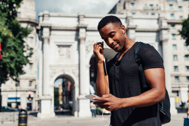 istock Handsome African guy with headphones and smart phone 922949942