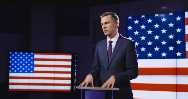 Presenter in front of American flag