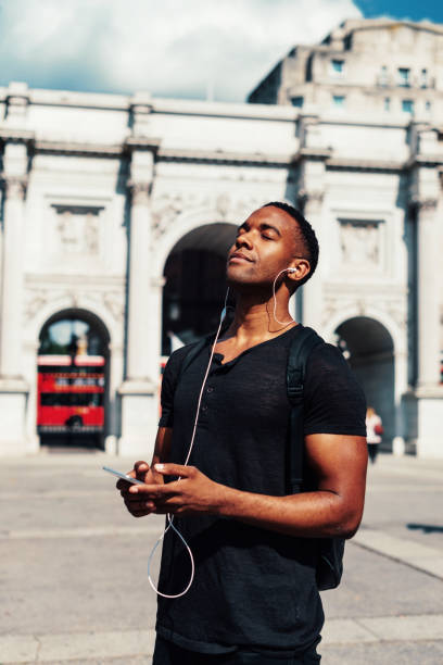 istock Handsome black guy in London, using mobile phone 922950302