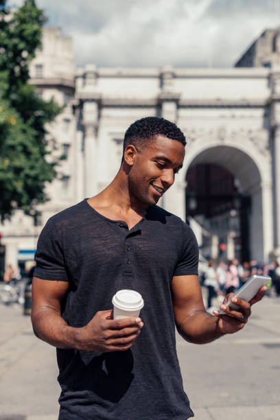 istock Handsome black guy using mobile app to call crowdsourced taxi 922950452