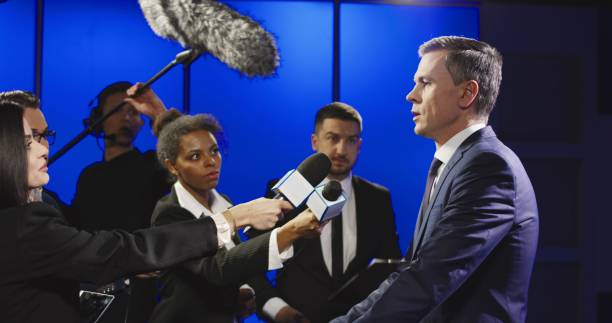istock Serious businessman talking to mass media representatives 922950846