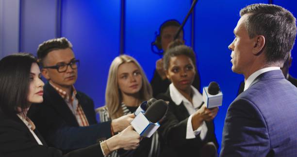 istock Serious businessman talking to mass media representatives 922950890
