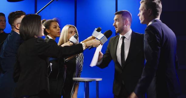 istock Businessman cutting off interview with reporters 922950956