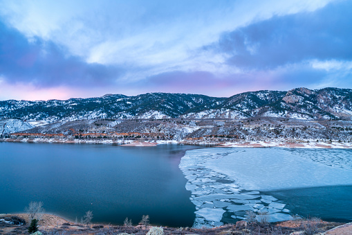 winter dawn over partially frozen mountain lake - Horestooth Reservoir near Fort Collins in northern Colorado, winter scenery before sunrise
