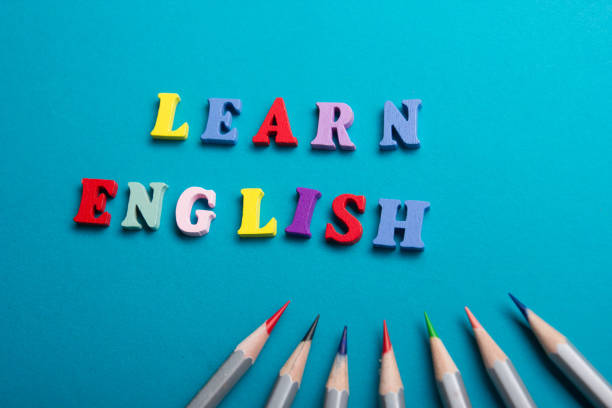 istock Learn English concept. Time to Learning languages. Word composed from colorful abc alphabet block wooden letters, copy space for ad text. 922954834