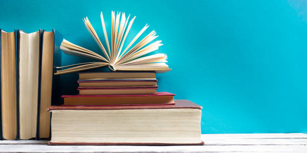 istock Open book, hardback books on wooden table. Back to school. Copy space 922958298